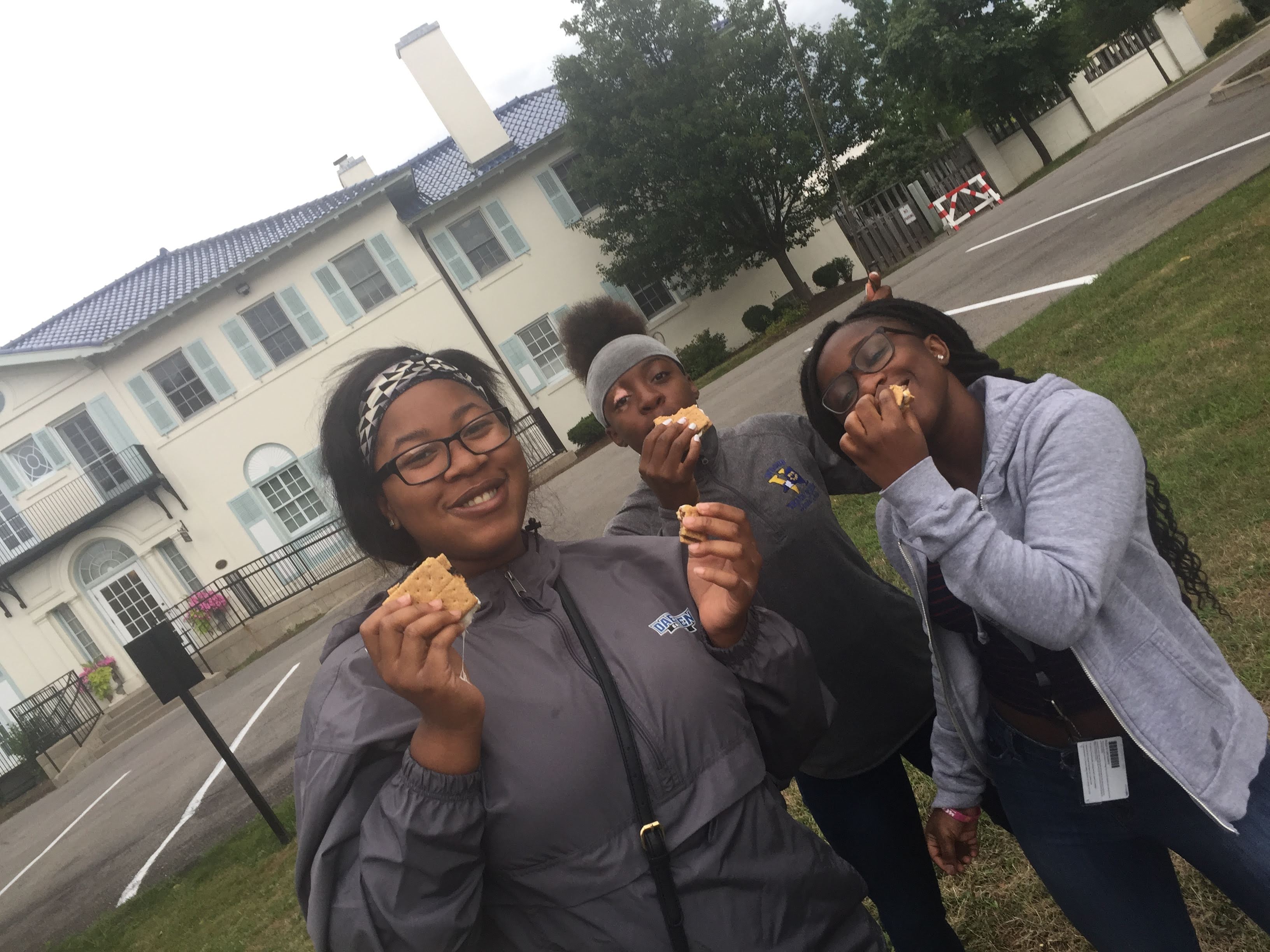 Students enjoy s'mores during campfire binding experience
