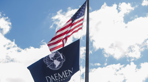 Daemen and US flag at front of campus