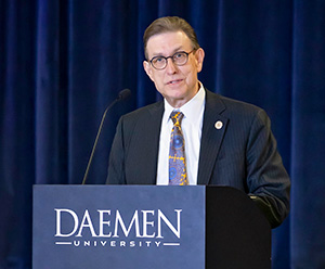 President Gary Olson speaking at podium