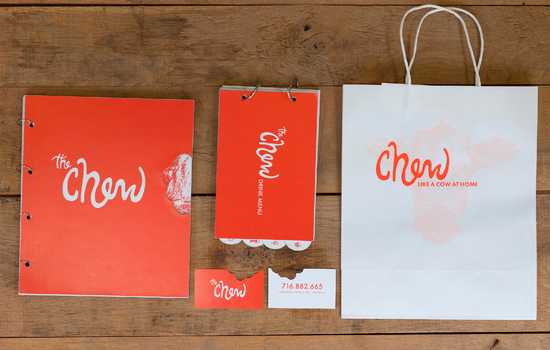 The Chew branding displayed on notebook, business cards and bag