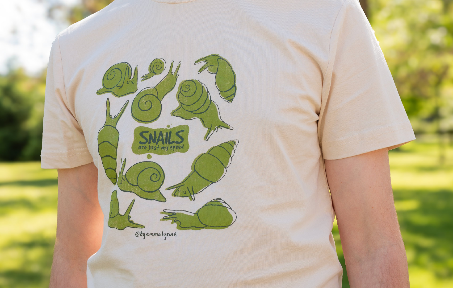 Person outdoors wearing a shirt with drawn snails on it 