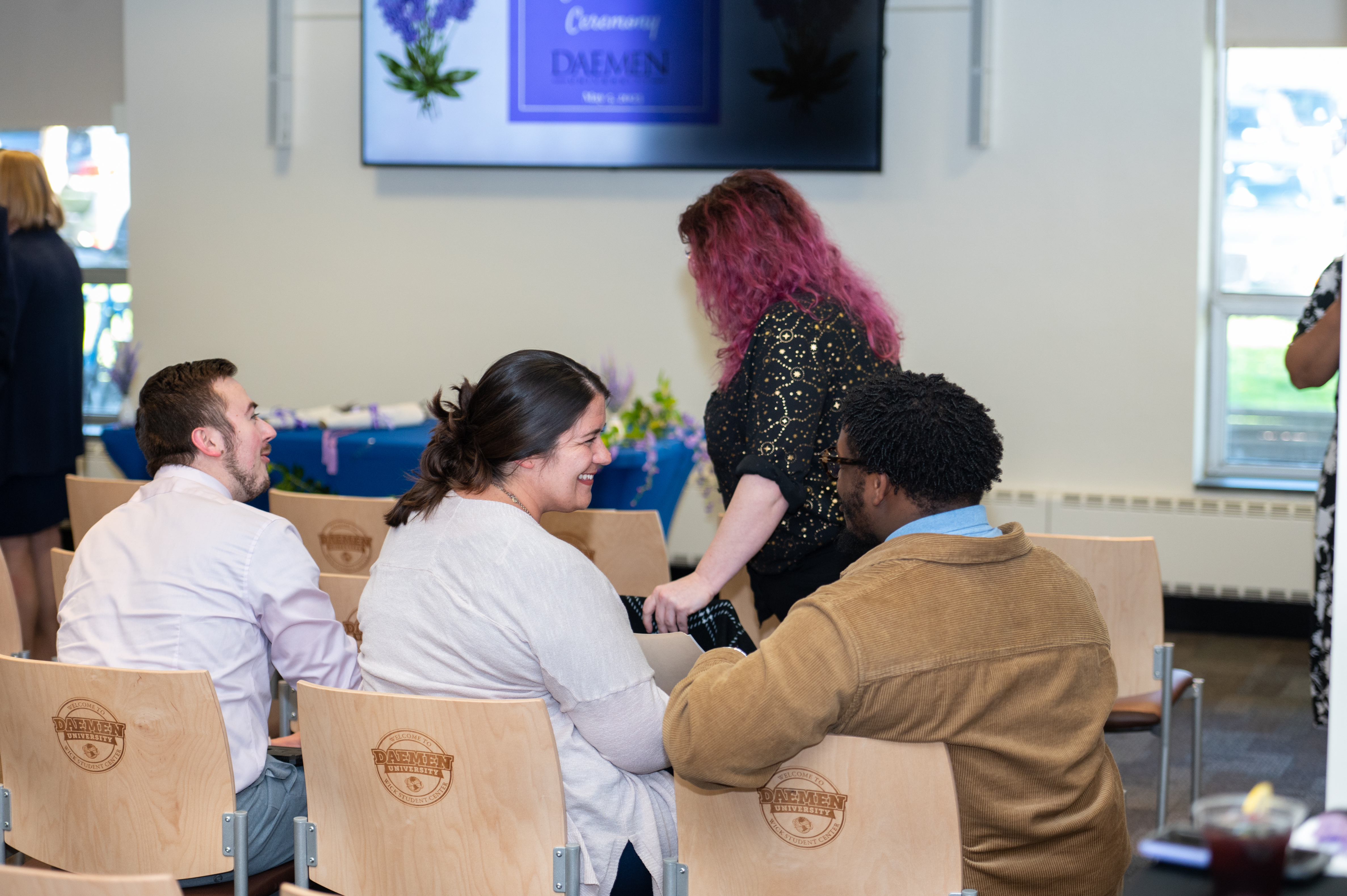 Two guests enjoy cordial conversation after the ceremony