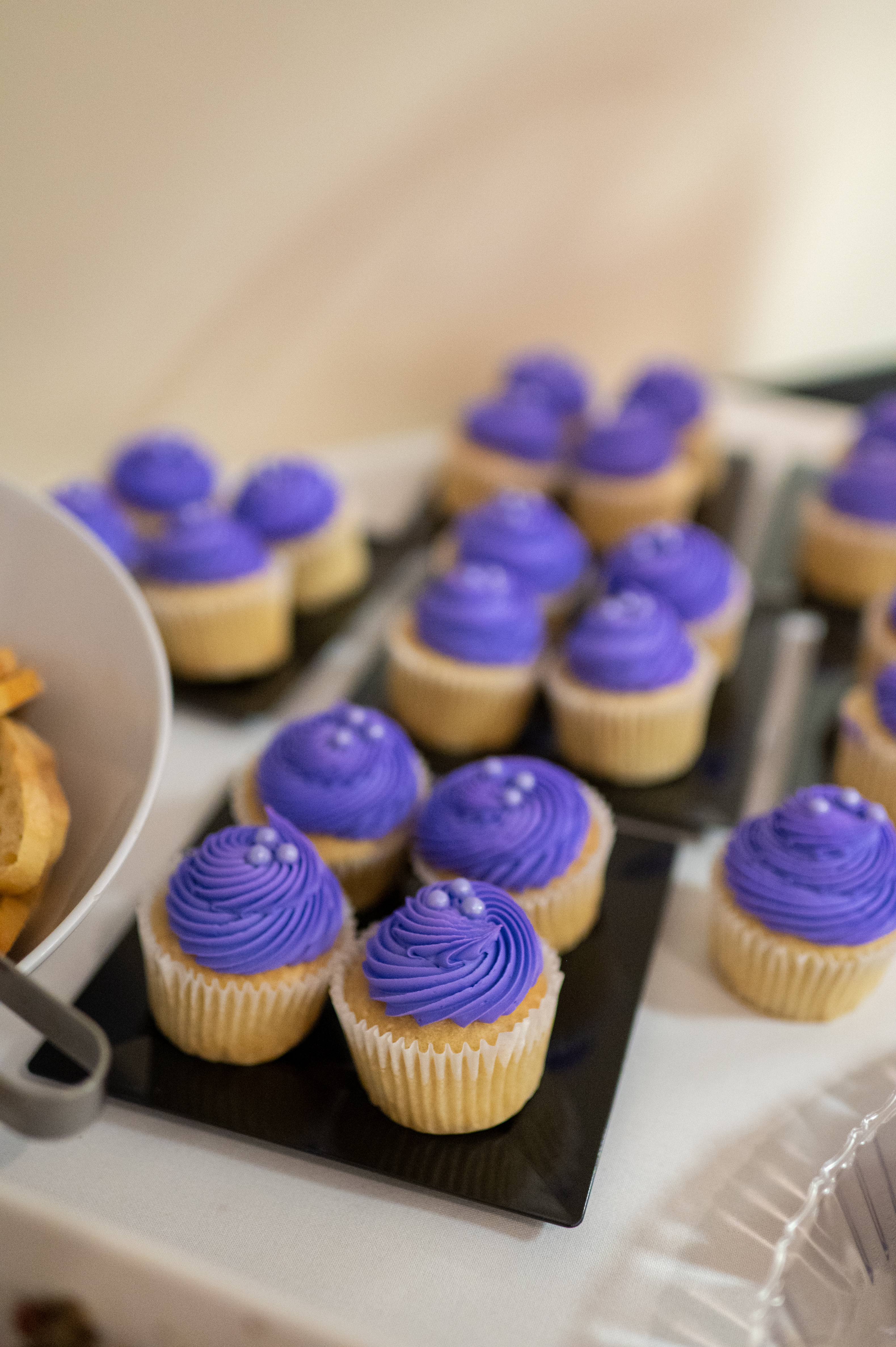 Trays of cupcakes with purple frosting