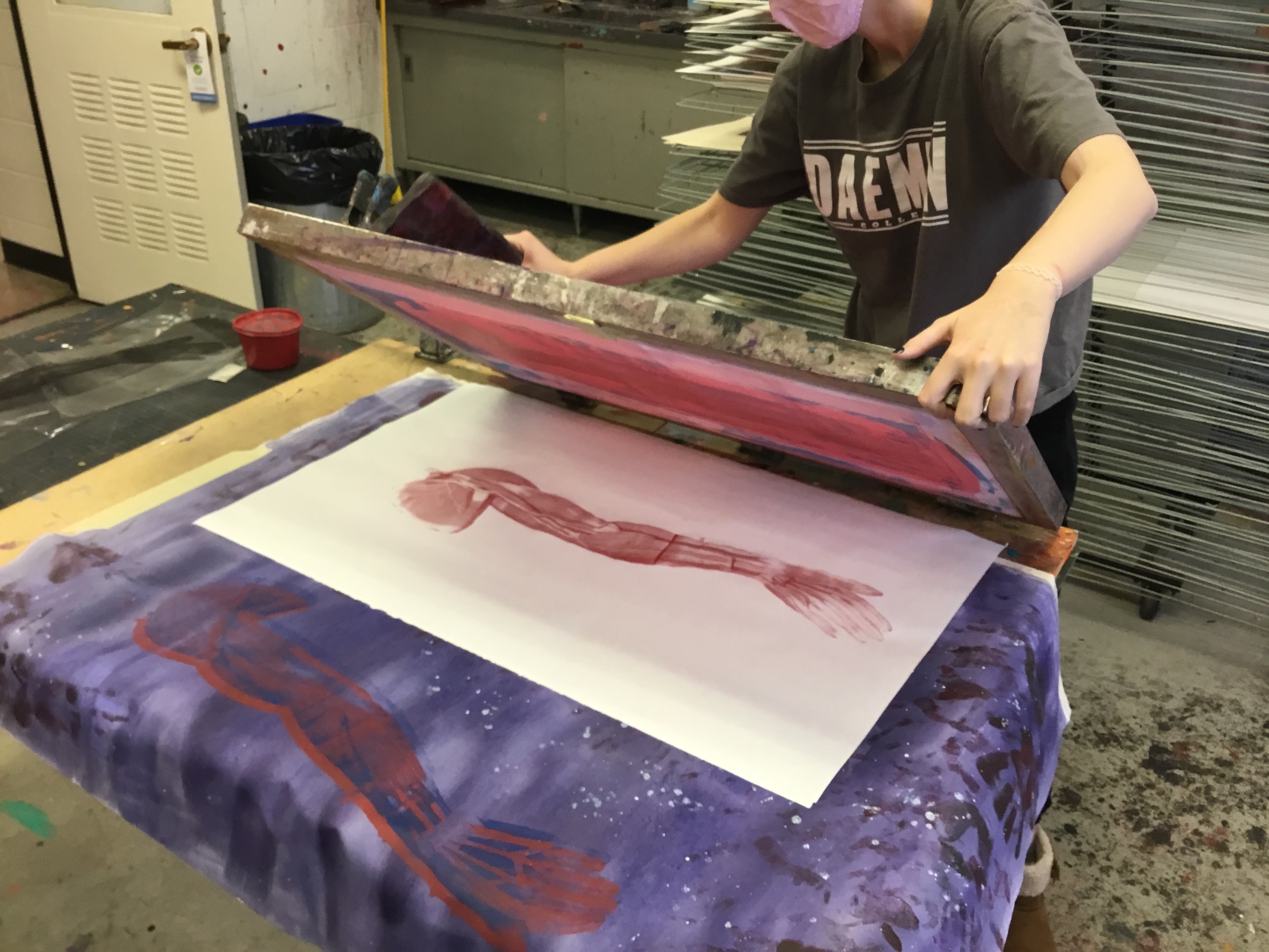 Erin Reilly Screen printing an anatomical rendering to a large canvas in Advanced Drawing