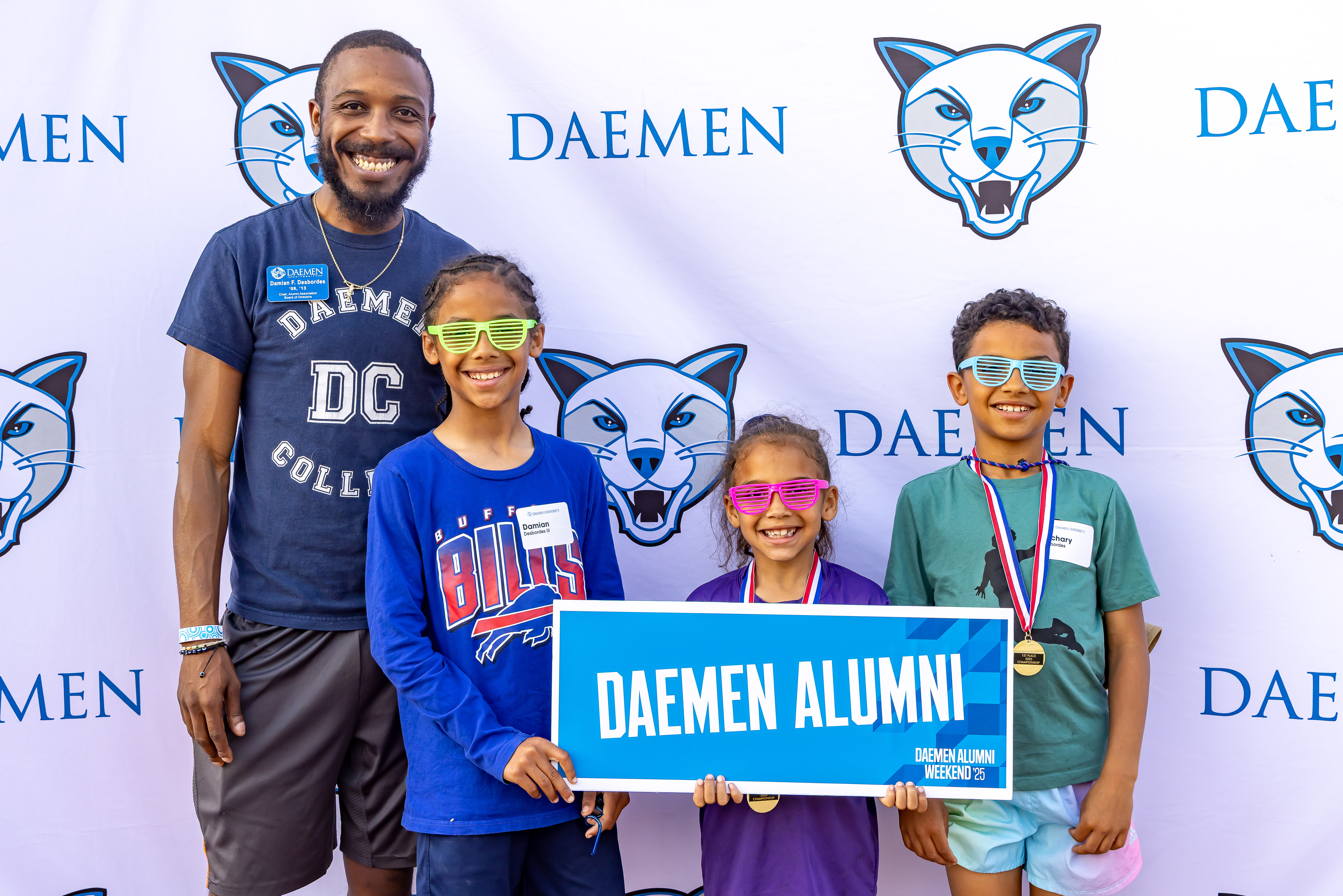 four people, behind backdrop