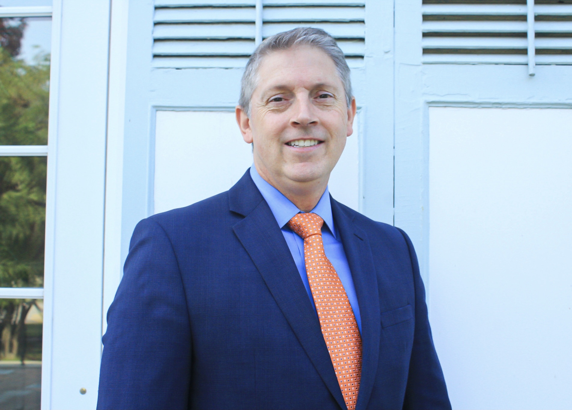 Greg Ford in a suit outside behind Rosary Hall