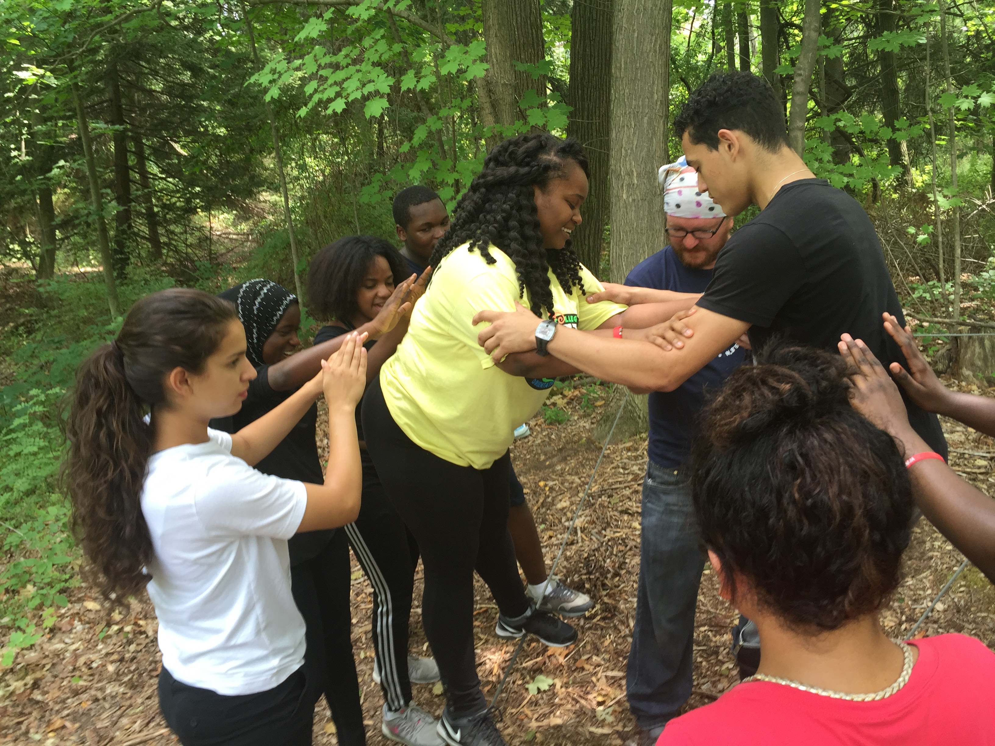 Students assisting each other in trust activities at Camp Keenan