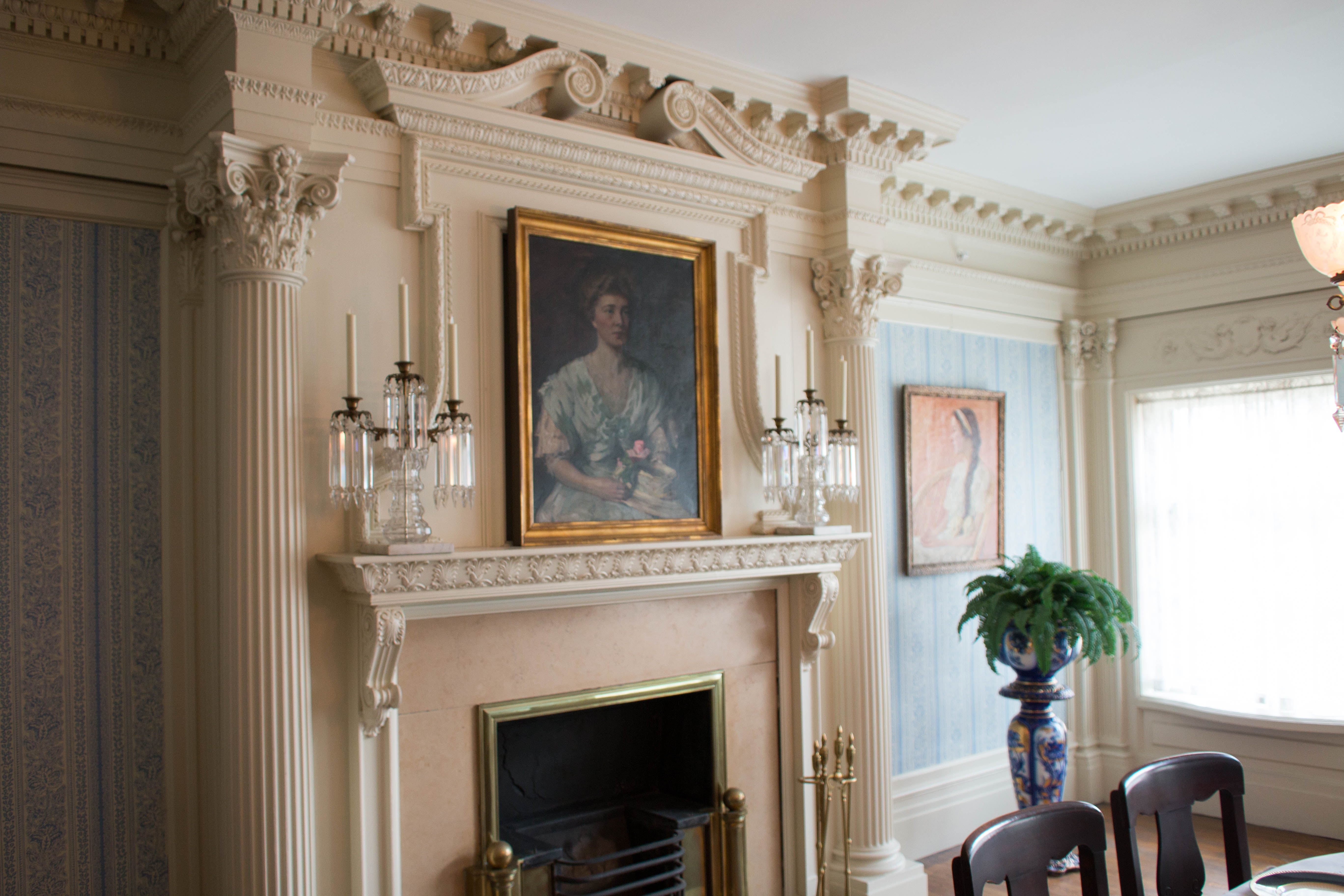 Painting hung over a marble fireplace
