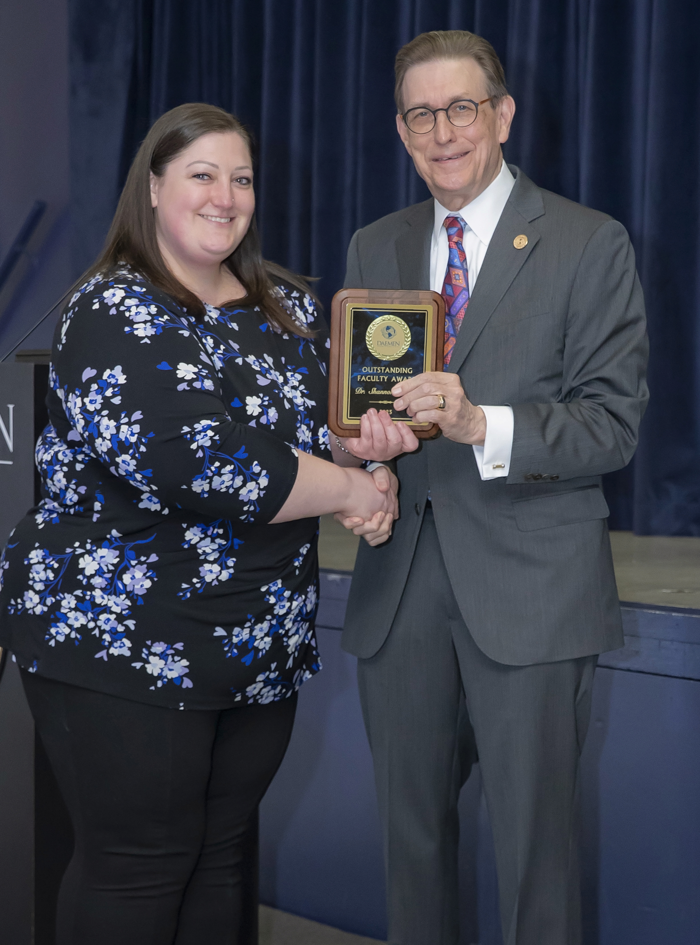 Shannon Lupien and President Olson with outstanding faculty member award