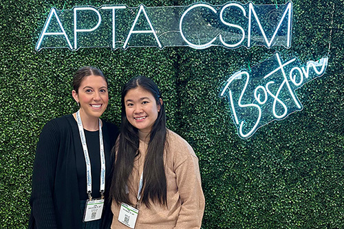 Julia nad Thao standingin front of APTA CSM neon blue sign