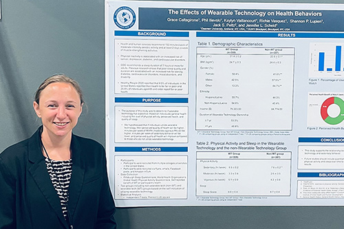 Grace Caltagirone standing next to poster presentation