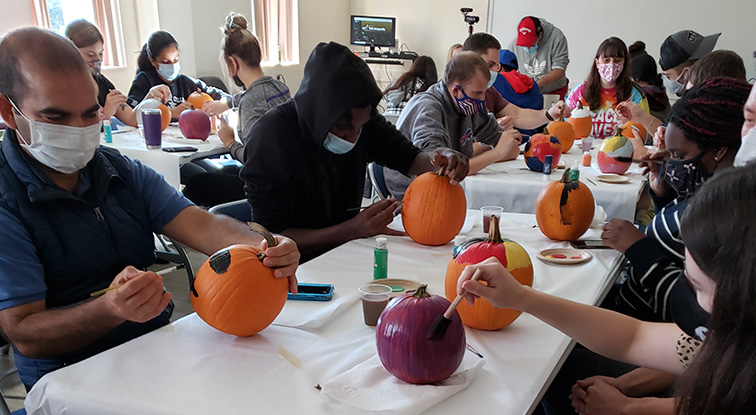 Students decorating pumpkins