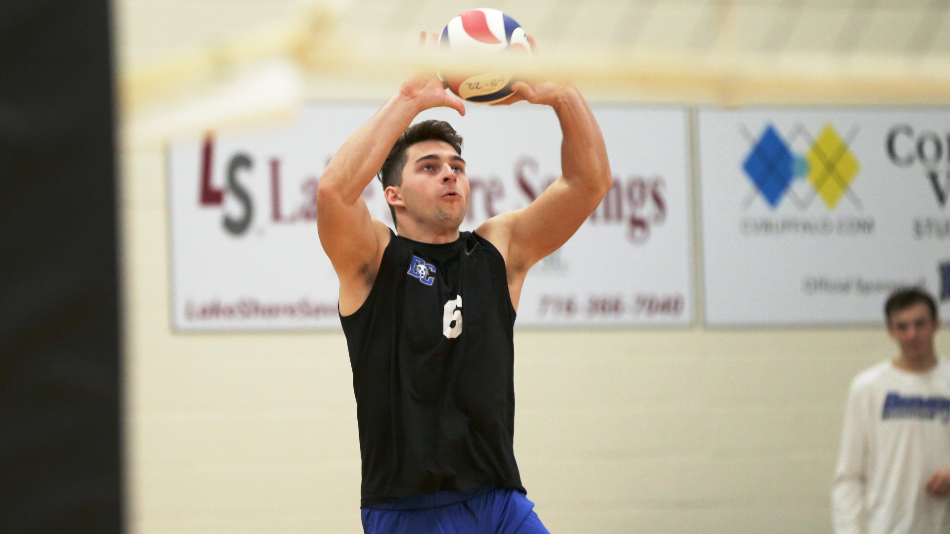 Jaden Gillette setting a volleyball