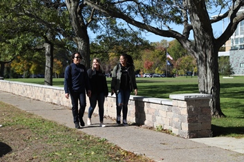 Students Walking by Wall