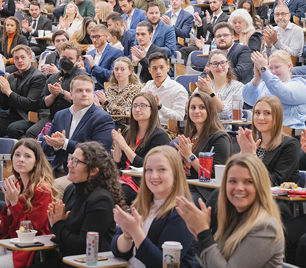 Symposium participants applauding 
