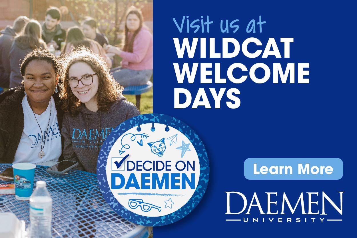 Students smiling sitting outside