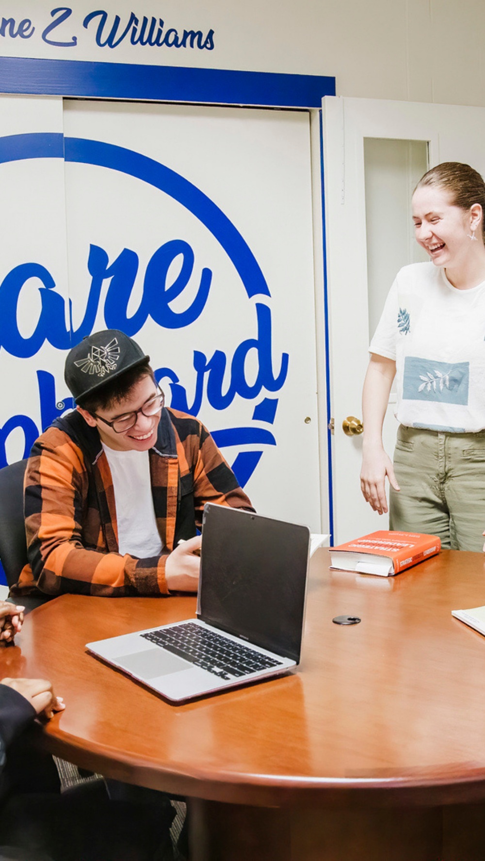 Students sitting at table care cupboard office
