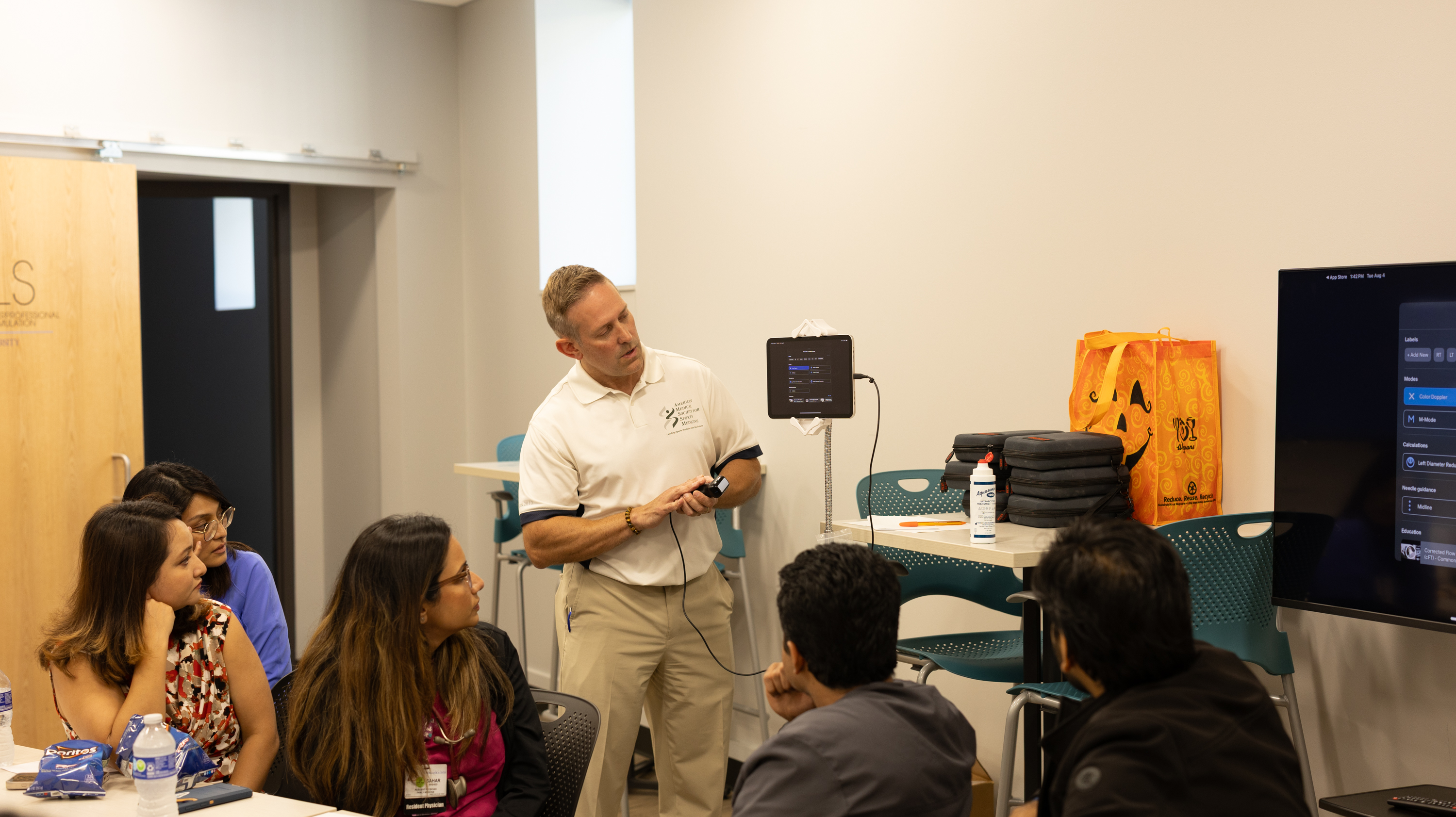Instructor demoing a tool in front of students