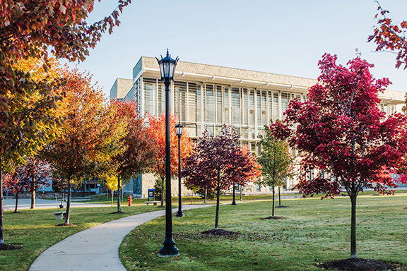 RIC in fall with red and yellow leaves on trees, viewed from concrete pathway