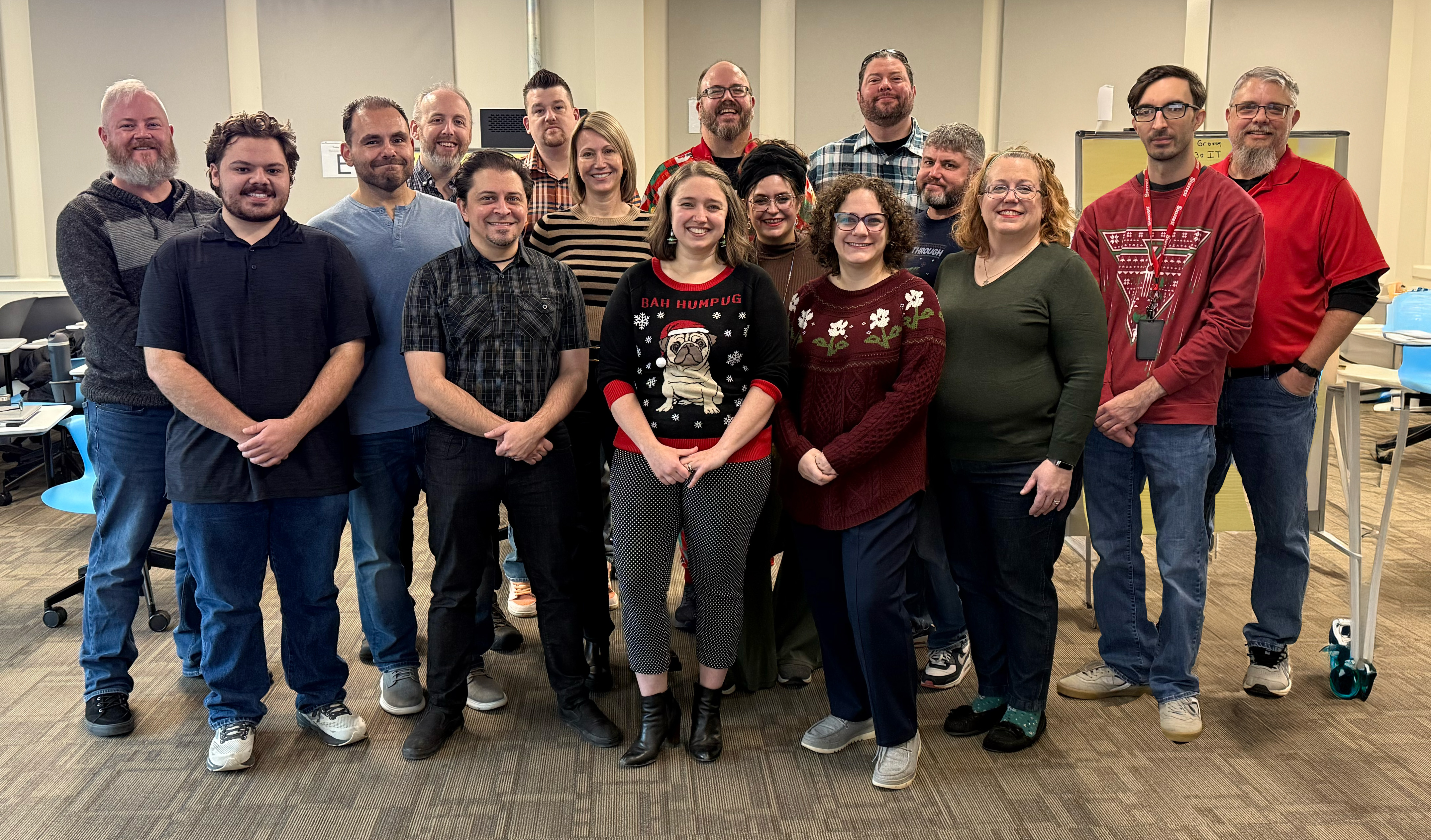 IT staff in classroom posing for camera