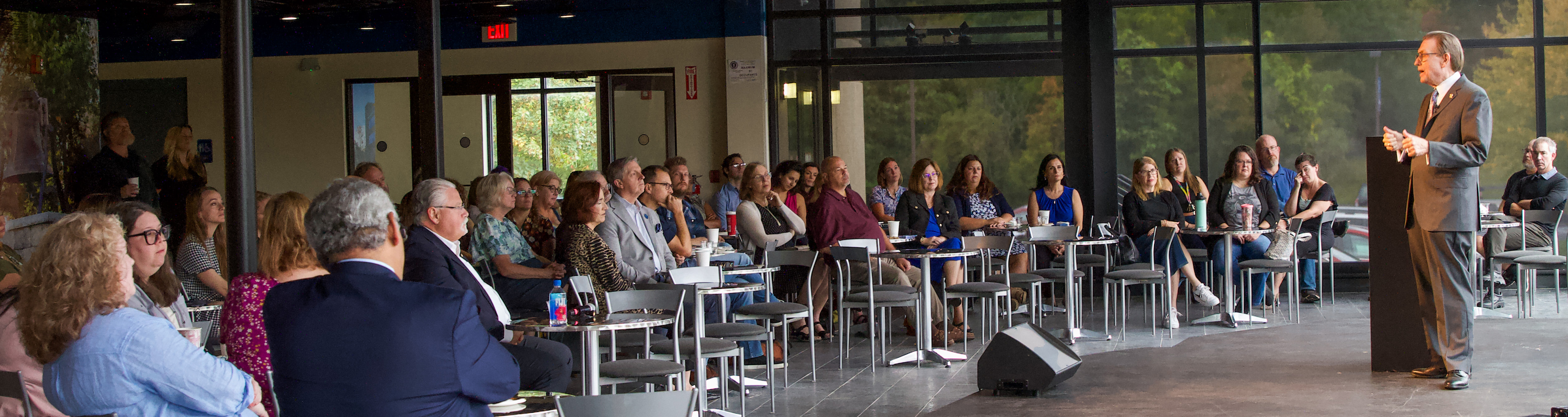 President Olson speaking in front of crowd at Daemen Hall