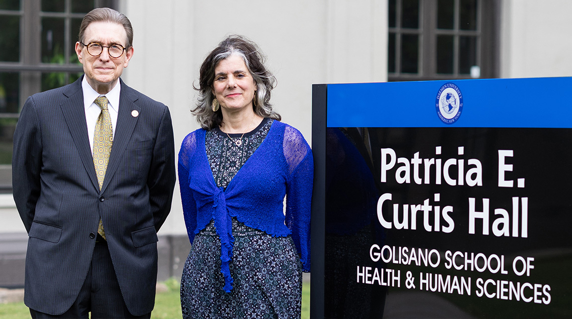 President Olson and Dr. Lisa Rafalson stadning by Galisano sign