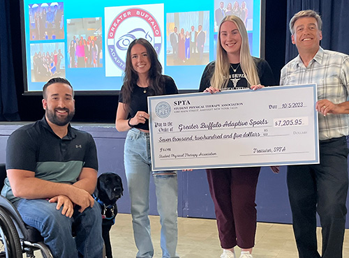 Ceremonial fundraising check being presented to Greater Buffalo Adaptive Sports