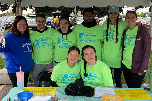 Daemen PT students wearing green Moving Day tshirts