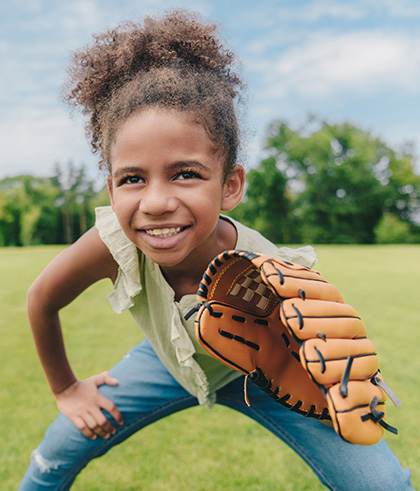 Adolescent girl wearing a baseball mitt