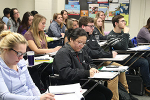 Students sitting in a class taking notes