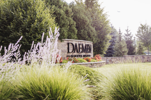Daemen sign as viewed from the flower garden in front of it