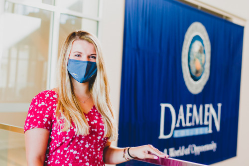 Female Daemen Student wearing a mask standing in the RIC