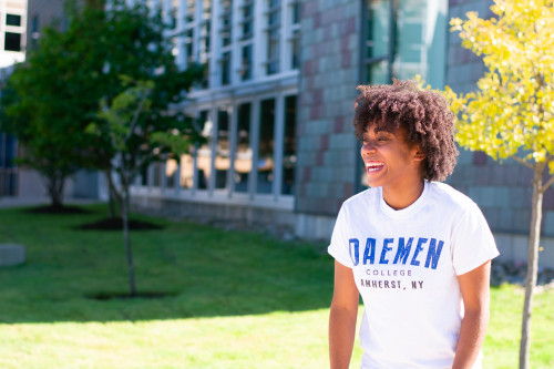 Female Daemen student laughing outside of the RIC