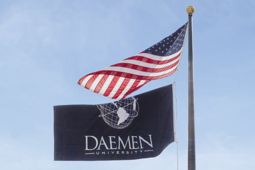 United States and Daemen flags on flag pole