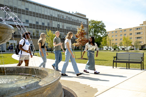students walking near fountain 