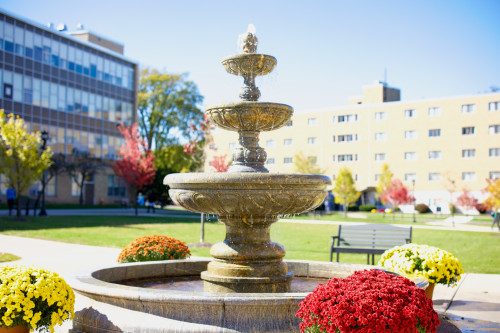 Marble fountain in the Saffrin Square in the autumn, with Duns Scotus and Canavan Hall in the background