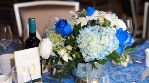 Annual Scholarship Gala  table setting, glasses, flowers