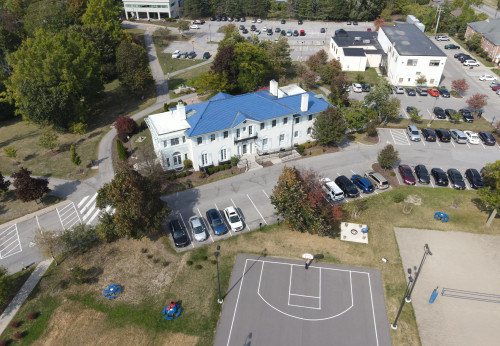 Aerial shot of the front of Rosary hall, part of the basketball and volleyball court are visible