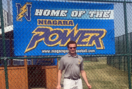 Male student in grey polo in front of Niagara Power sign