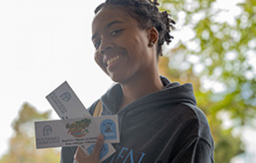 Student holding tickets for Food Truck Rodeo