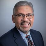 Dr. Tito Rodriguez, wearing a suit and tie