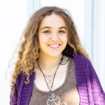 Sienna wearing a purple sweater