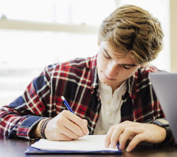 Daemen student going over class notes in the Research and Information Commons.