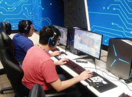Jose Mejia and Justin Fang playing League of Legends in the esports room