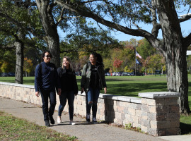 Students Walking by Wall