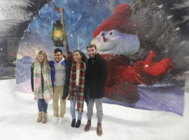 People standing in front of a snowman